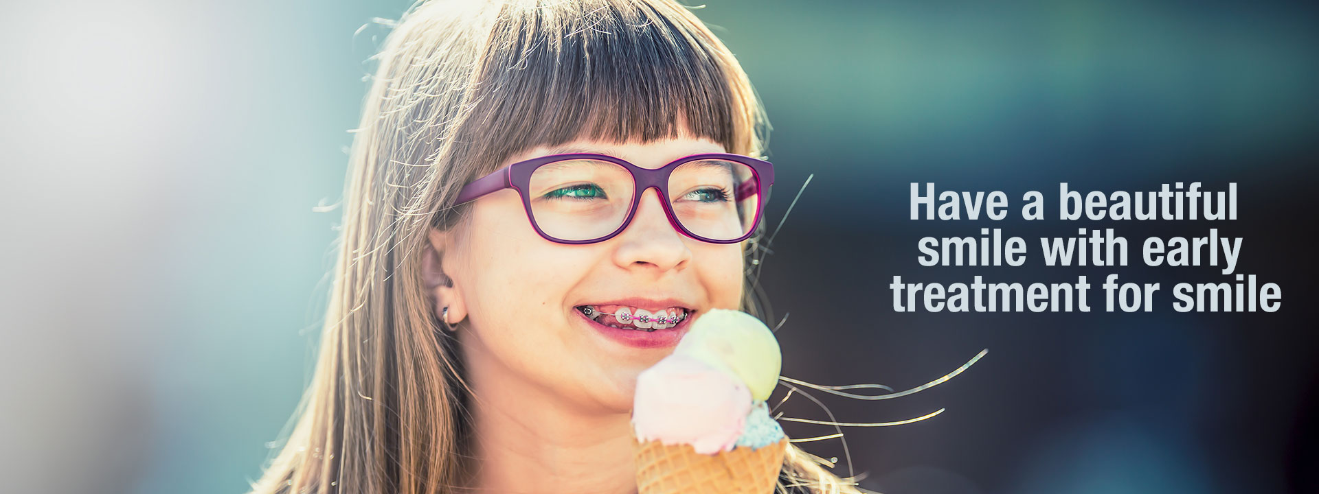 a girl with braces having icecream